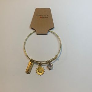Handmade gold tone stainless steel bracelet with 3 charms.
